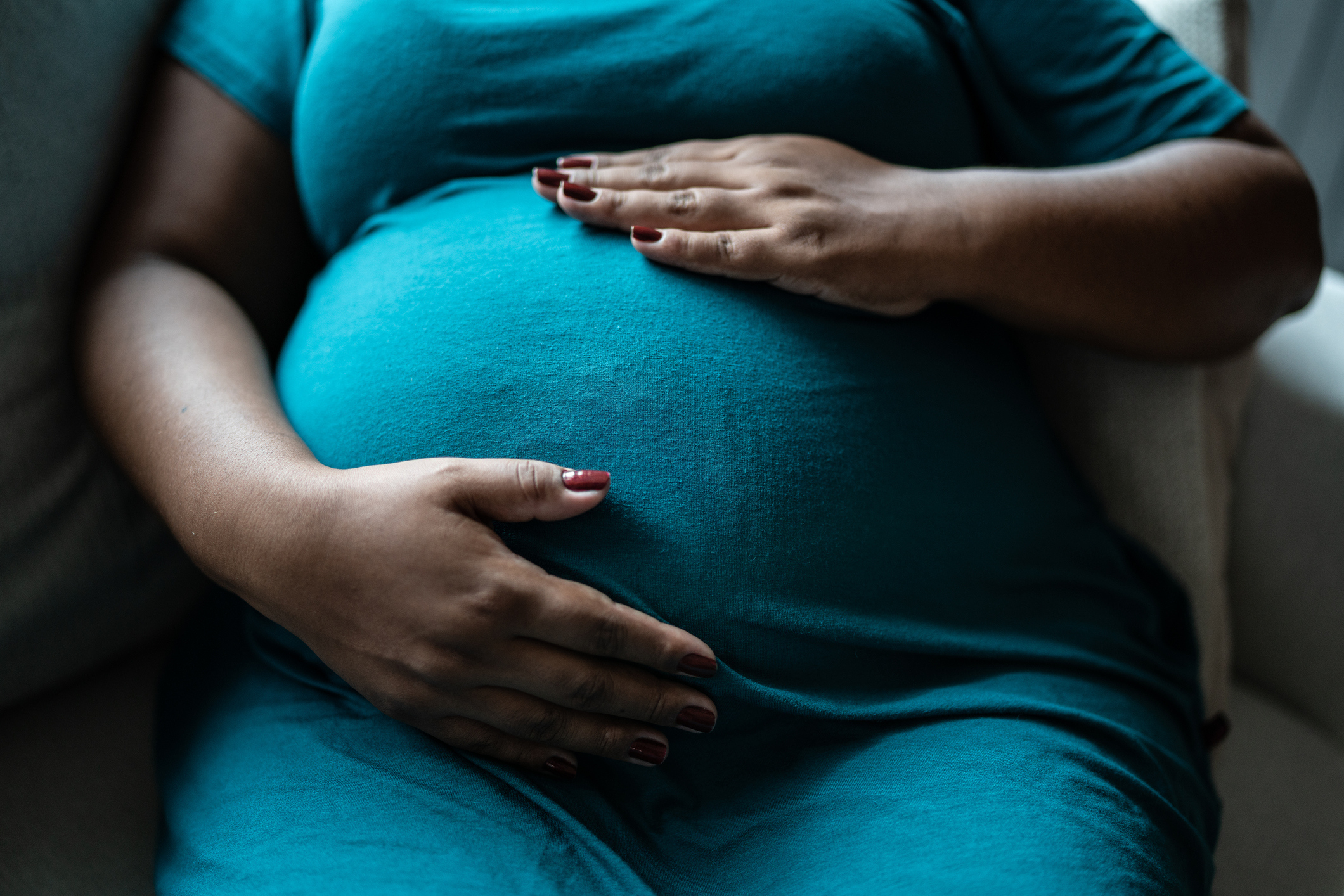 Pregnant women touching her belly