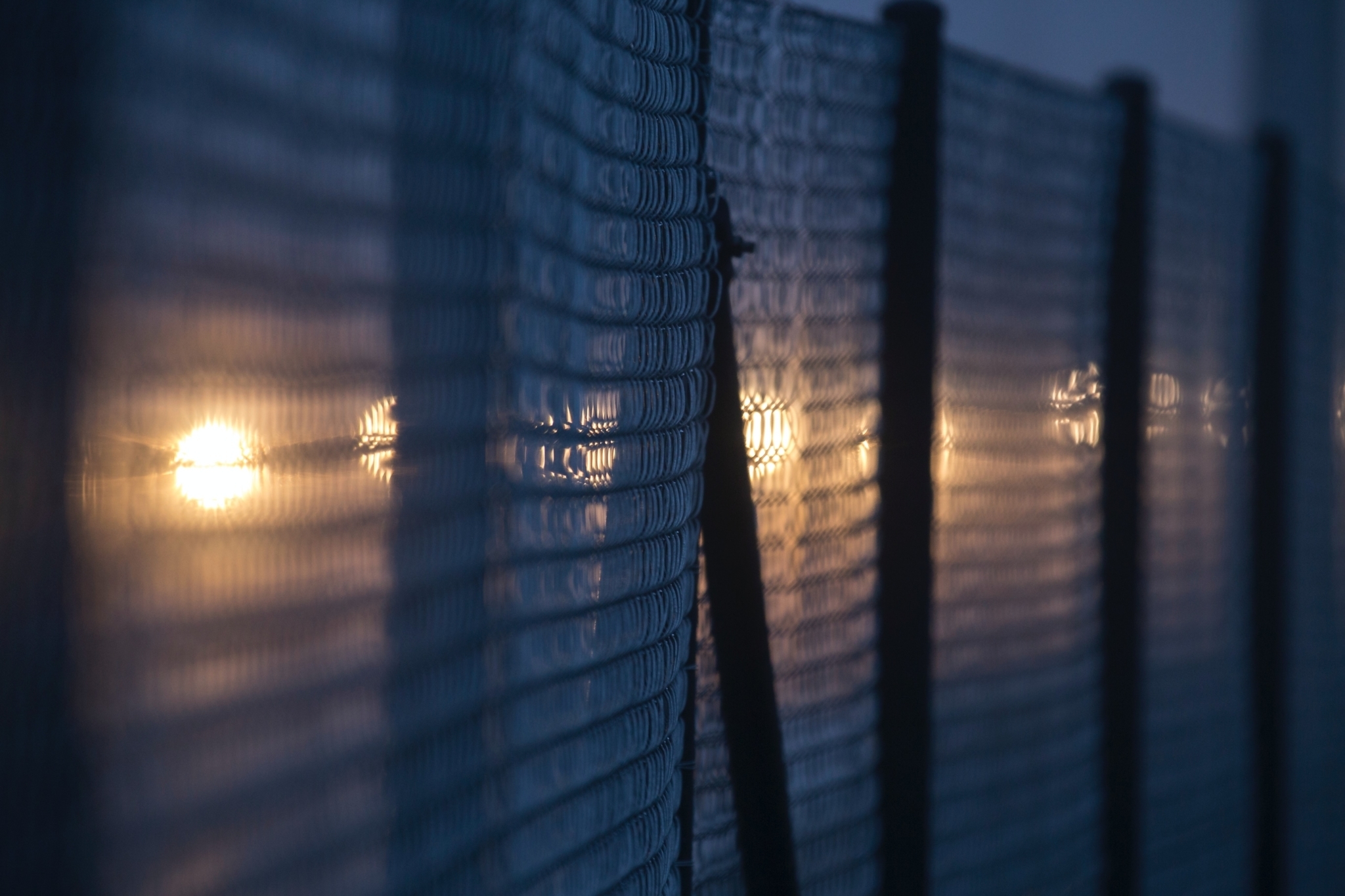 Fence with blurred lights in the background